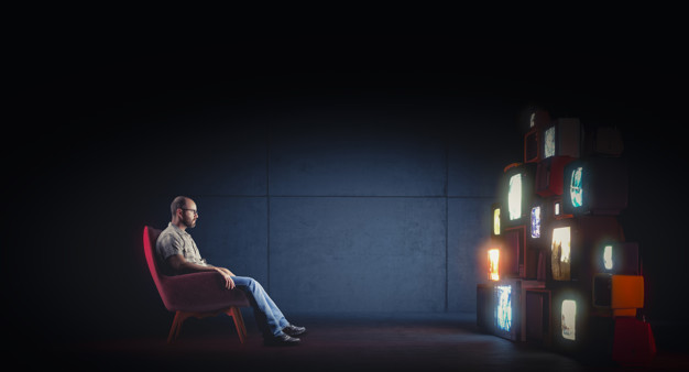 Caucasian Man With Glasses Sitting Armchair Watching Several Vintage Televisions 103577 5452